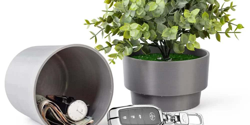 Plastic flower pot diversion safe with a twist off base that hides a storage compartment